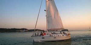 Boat trip on the Tagus River in Lisbon by sailboat or catamaran during sunset
