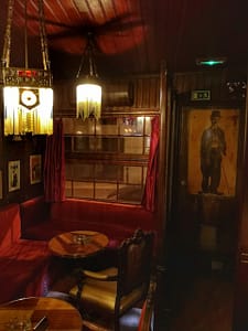 A Parodia cocktail bar in Lisbon, an old school speakeasy entirely decorated with creations by Rafael Bordalo Pinheiro