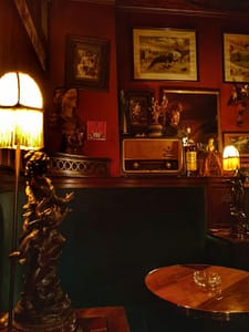 A Parodia cocktail bar in Lisbon, an old school speakeasy entirely decorated with creations by Rafael Bordalo Pinheiro