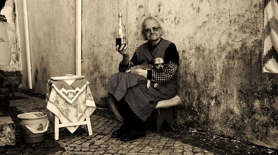 A grandmother selling ginja in the streets of Alfama