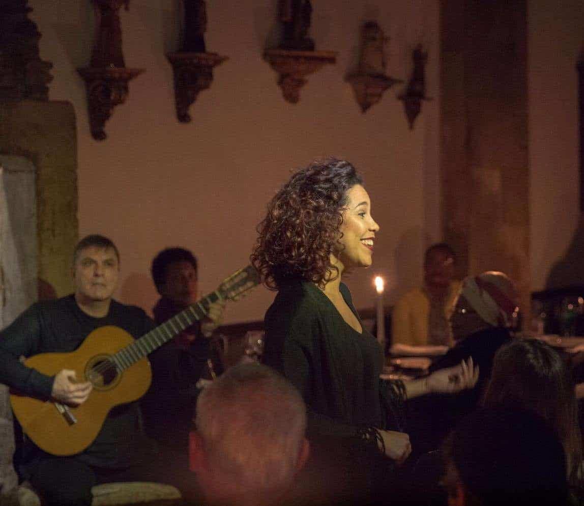 Beautiful fadist in a fado restaurant in Alfama for the best fado night in Lisbon