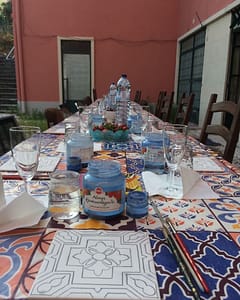 Painting a tile during an azulejos workshop in Lisbon