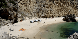 Event day on a secluded beach in Lisbon with water activities, fun, salad buffet