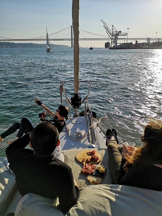 Early evening aperitif on the Tagus: cheese and charcuterie tapas on a catamaran in Lisbon during sunset
